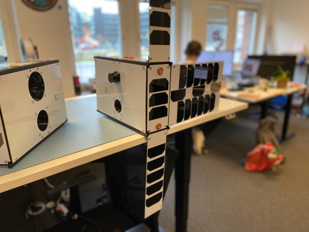 6U CubeSat prototype structure with solar panel arrays on the bench at the Kista office — engineering model, not flight hardware
