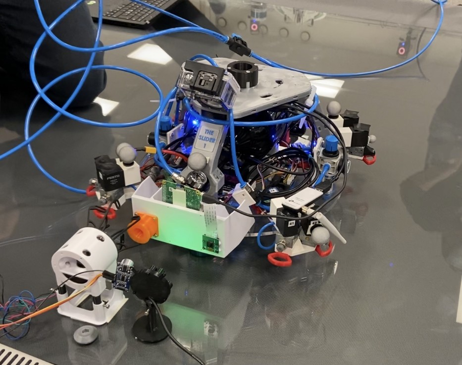 LTU Luleå University, September 2022 — 2D air-bearing slider testbed used to validate the docking port mechanics and GNC controller in 2 degrees of freedom, with the VBN LED target frame visible on the chaser