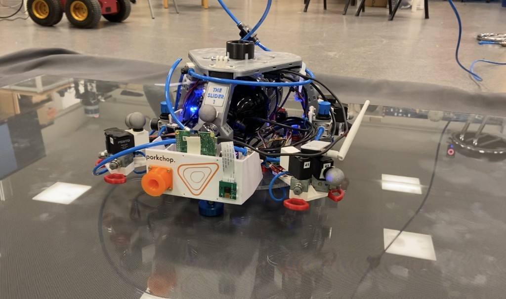 LTU Luleå University, September 2022 — 6U CubeSat chaser floating on the planar air-bearing floor during docking approach, validating 2-DOF controller performance and docking port alignment