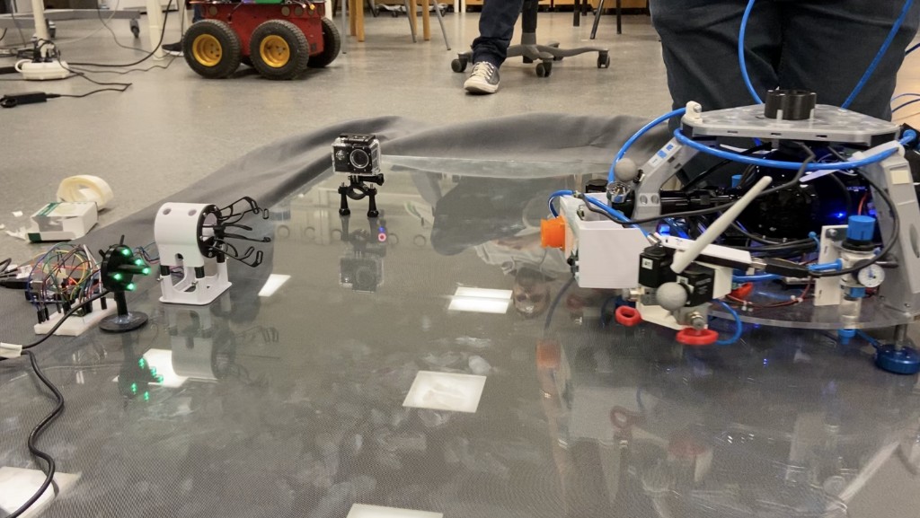 LTU Luleå University, September 2022 — air-bearing slider testbed showing the LED frame and Raspberry Pi camera on the mothership active for Vision-Based Navigation during the docking sequence